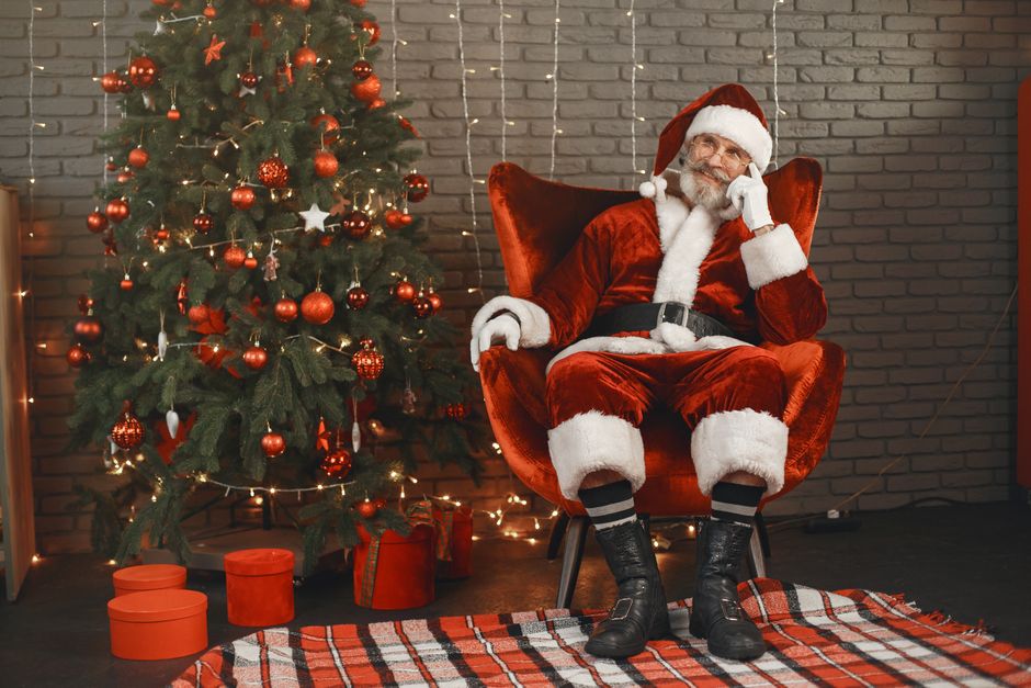 A child listening to a message from Santa Claus on a phone